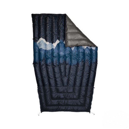 A flat lay with flap custom revelation with a mountain range displayed on the front of the navy blue quilt.