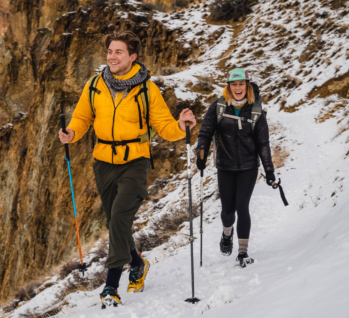 Apparel - a couple of backpackers in insulated apparel walking a snowy trail