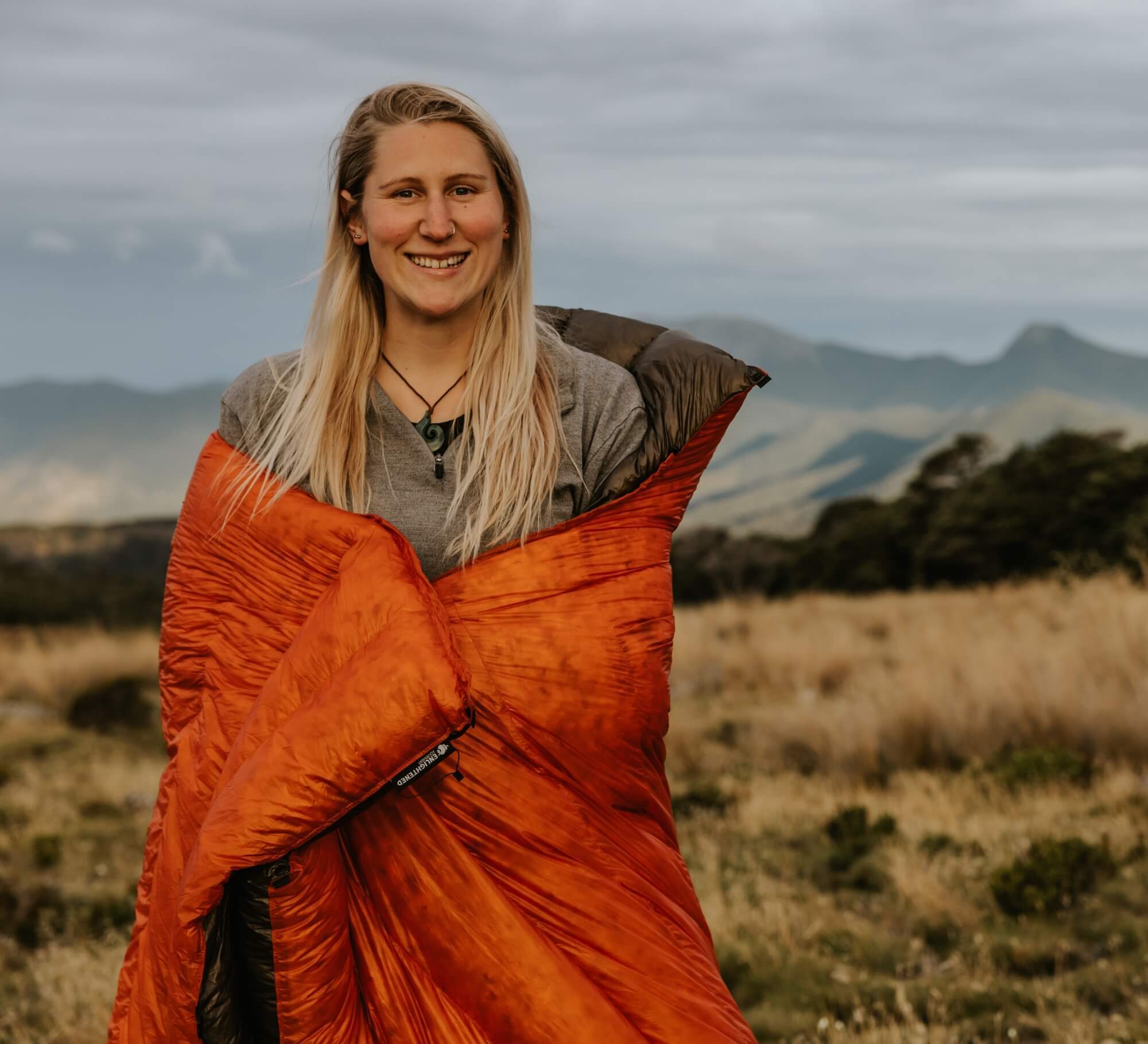 Review Image 4 - a woman wrapping an Accomplice around her in the outdoors